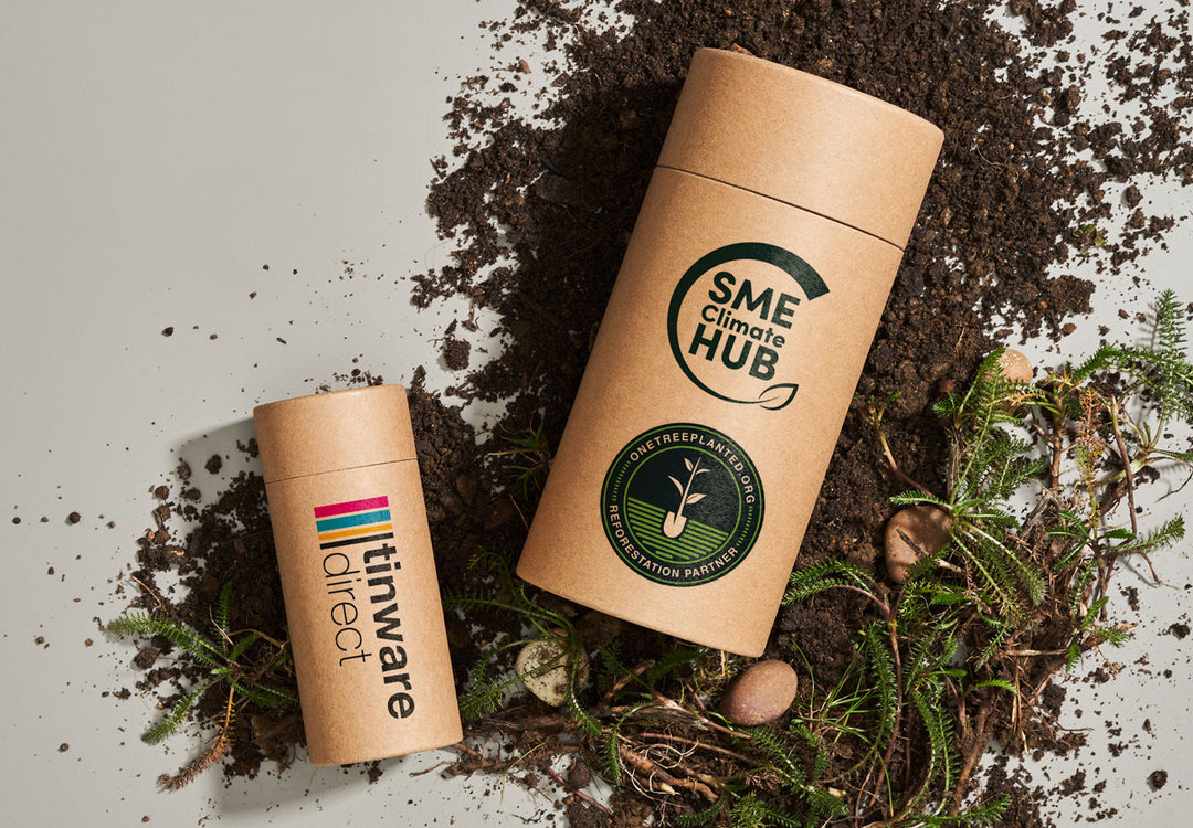 Dos tubos de cartón de la marca Tinware Direct. Un tubo tiene el logotipo de One Tree Planter Reforestation Partner y el logotipo de SME Climate Hub. 